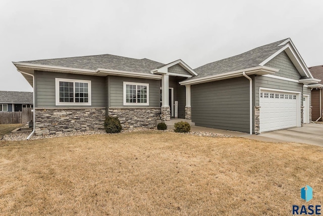 view of front of property with a garage and a front lawn