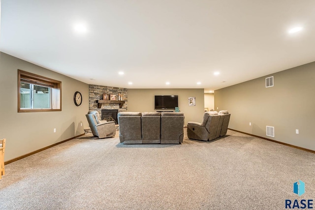 living room with a stone fireplace and light colored carpet