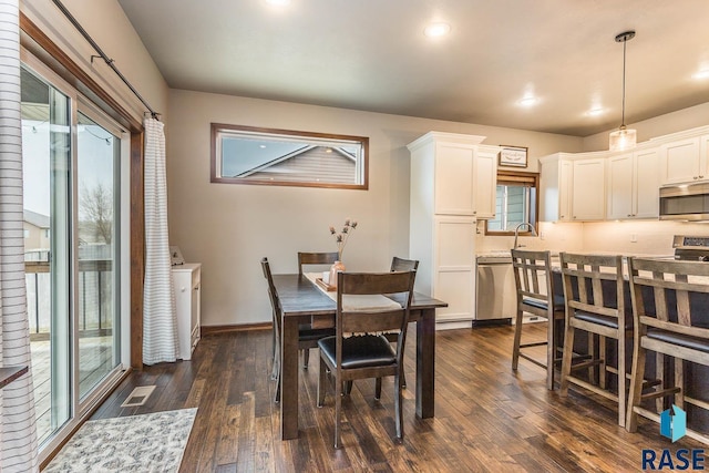 dining space featuring dark wood-type flooring