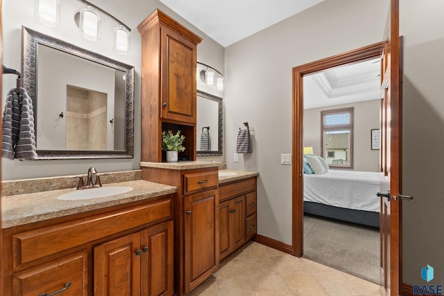 bathroom featuring vanity, a tray ceiling, and tile patterned flooring