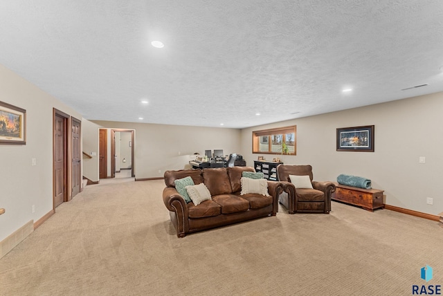 carpeted living room featuring a textured ceiling