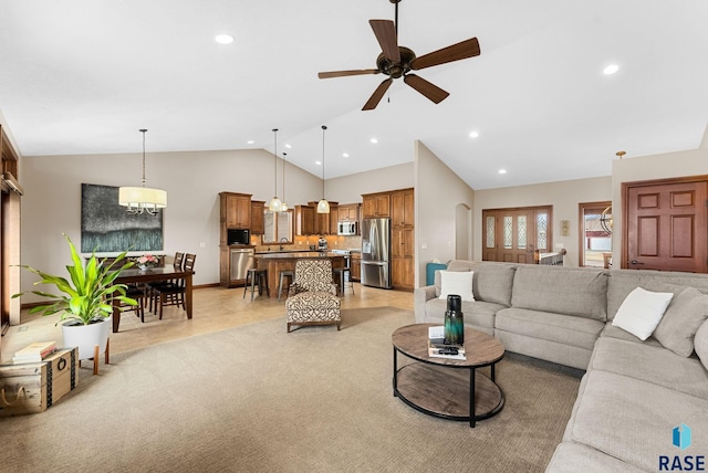 carpeted living room featuring sink, high vaulted ceiling, and ceiling fan