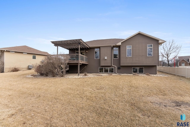 rear view of property with a pergola, a deck, and a lawn