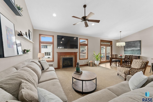 living room with vaulted ceiling, light colored carpet, ceiling fan, and plenty of natural light