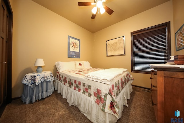 bedroom with ceiling fan and dark carpet