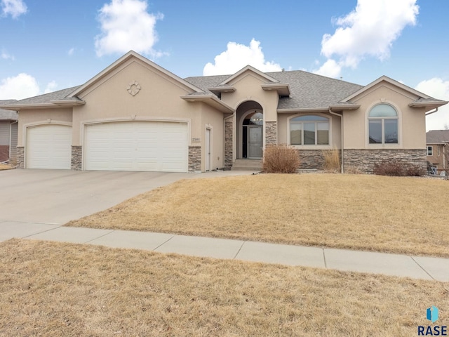 ranch-style house with a garage and a front yard