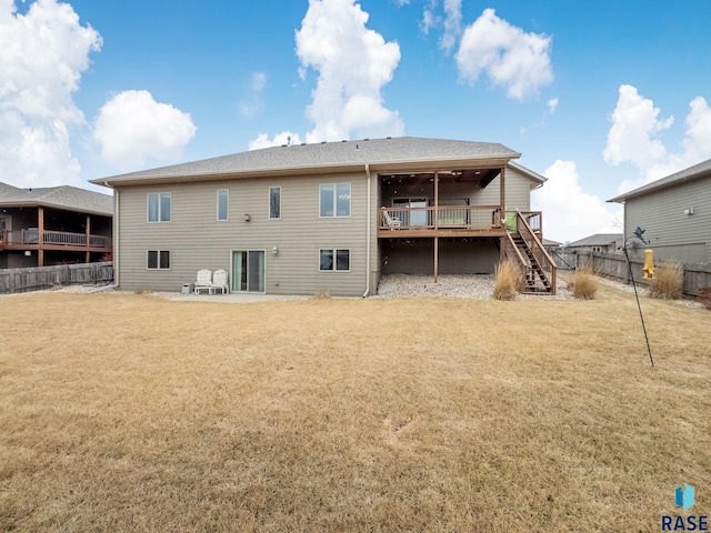 back of house with a yard and a deck