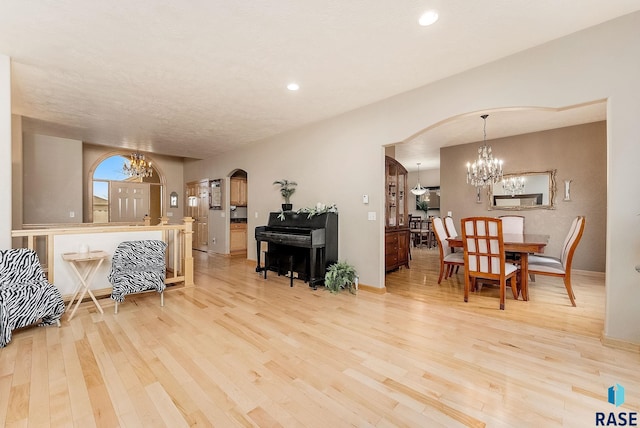 interior space featuring light hardwood / wood-style flooring and a notable chandelier