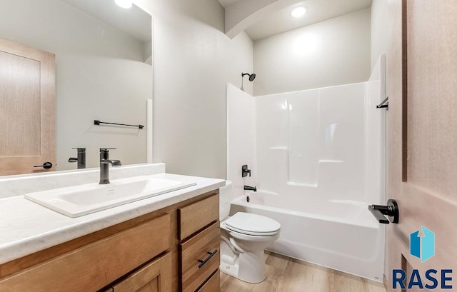 1004 N Juniper St, Lennox, SD 57039 - full bathroom with vanity, wood-type flooring, shower / washtub combination, and toilet