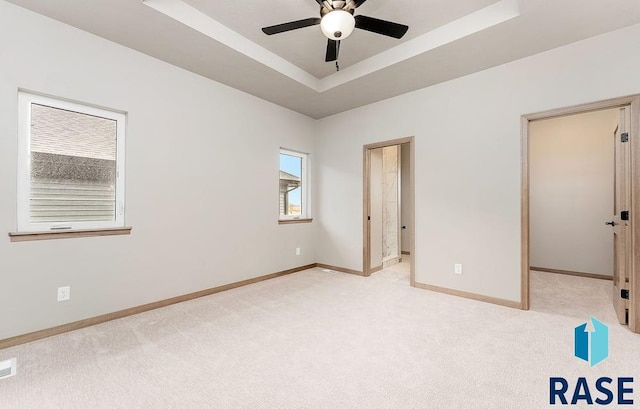 1004 N Juniper St, Lennox, SD 57039 - unfurnished bedroom with light colored carpet and a raised ceiling