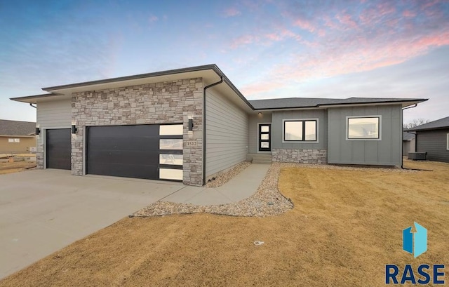 view of front of home featuring central AC and a garage