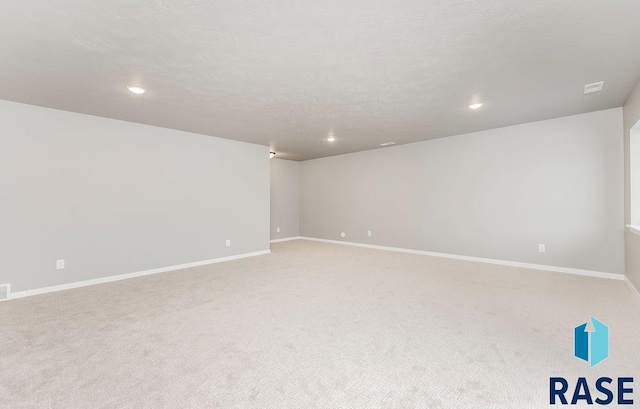 carpeted spare room with a textured ceiling