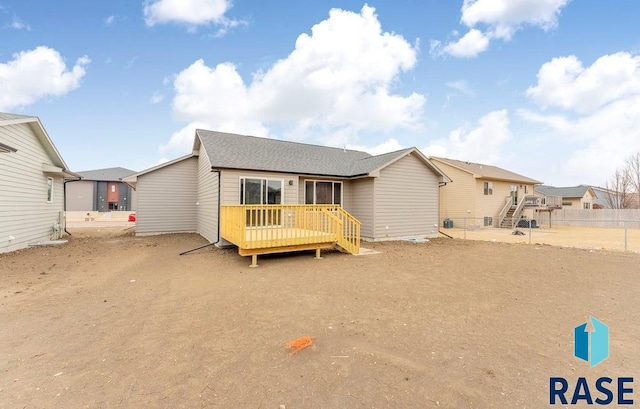 back of property with a wooden deck