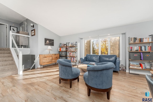 sitting room with light hardwood / wood-style flooring and vaulted ceiling