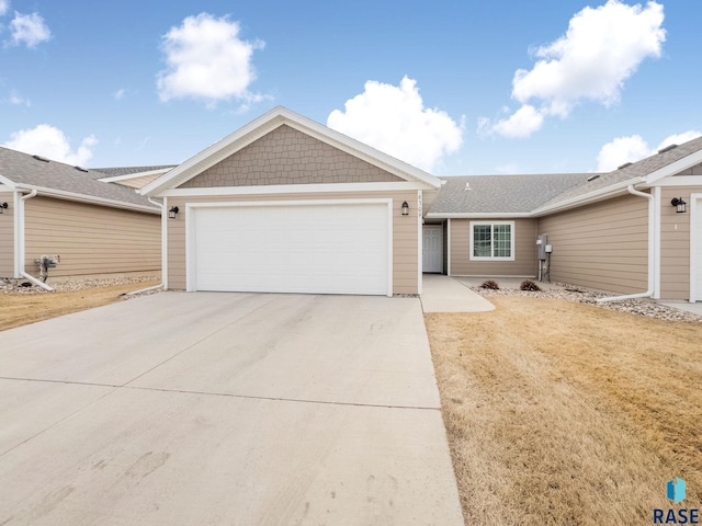 single story home featuring a garage and a front lawn