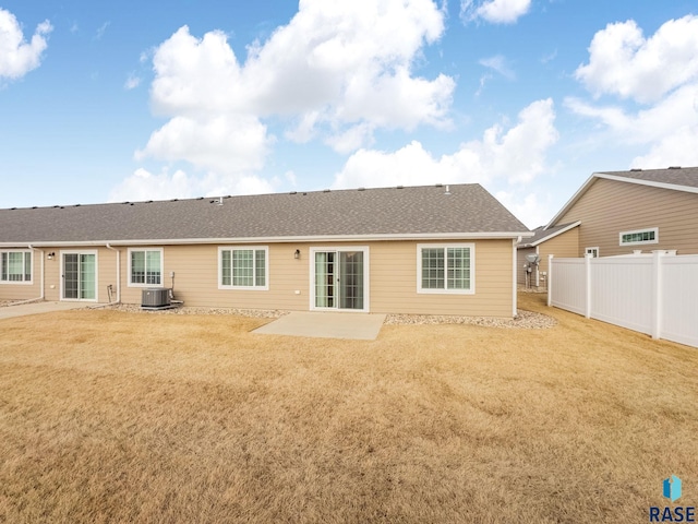 rear view of house with a yard, a patio area, and central air condition unit