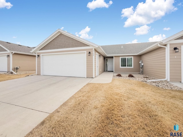 ranch-style house with a garage and a front yard