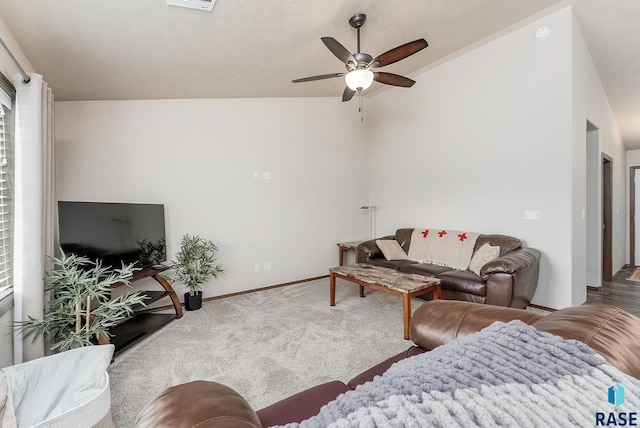 living room featuring carpet floors, vaulted ceiling, and ceiling fan