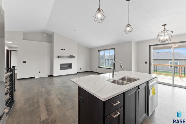 kitchen with a kitchen island with sink, sink, pendant lighting, and dishwasher