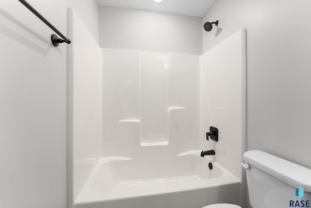 bathroom featuring tub / shower combination and toilet