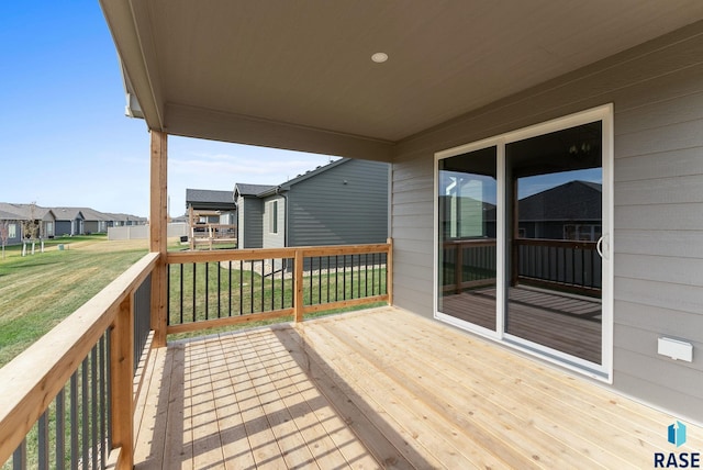 wooden deck featuring a yard