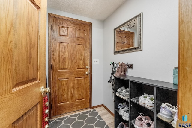 entryway featuring a textured ceiling and light wood-type flooring