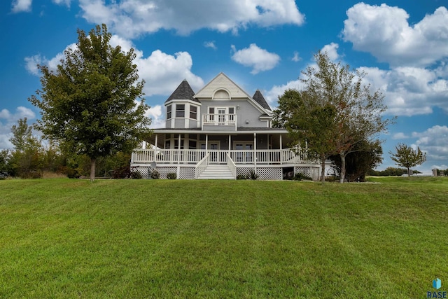 back of house featuring a yard and covered porch