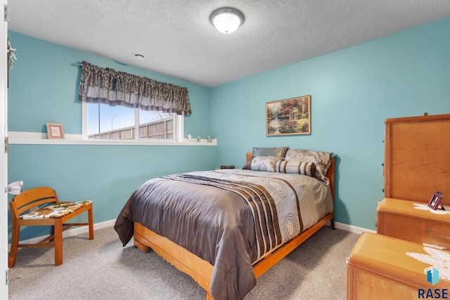 carpeted bedroom with a textured ceiling