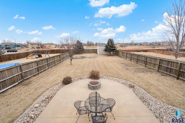 view of patio / terrace with a playground and an outdoor fire pit