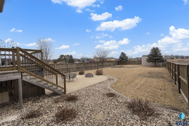 view of yard with a patio and an outdoor fire pit