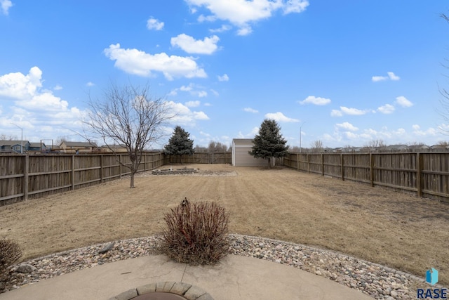 view of yard featuring a storage shed and a patio