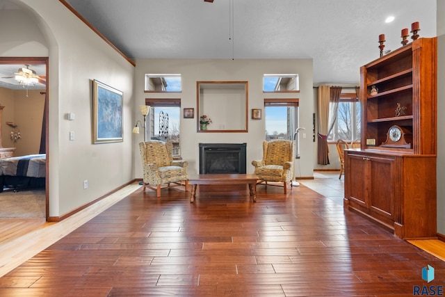 sitting room with hardwood / wood-style flooring, a textured ceiling, and ceiling fan