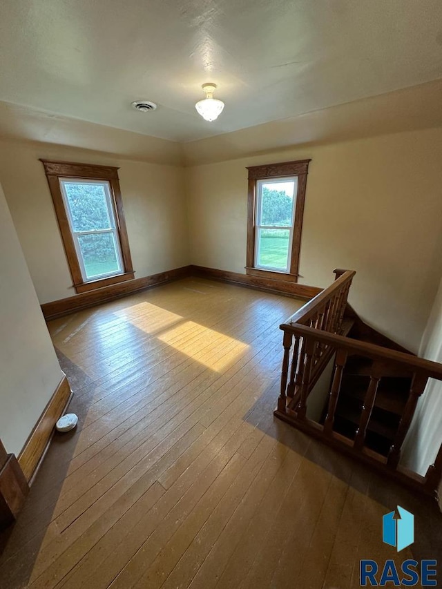 bonus room with dark hardwood / wood-style floors