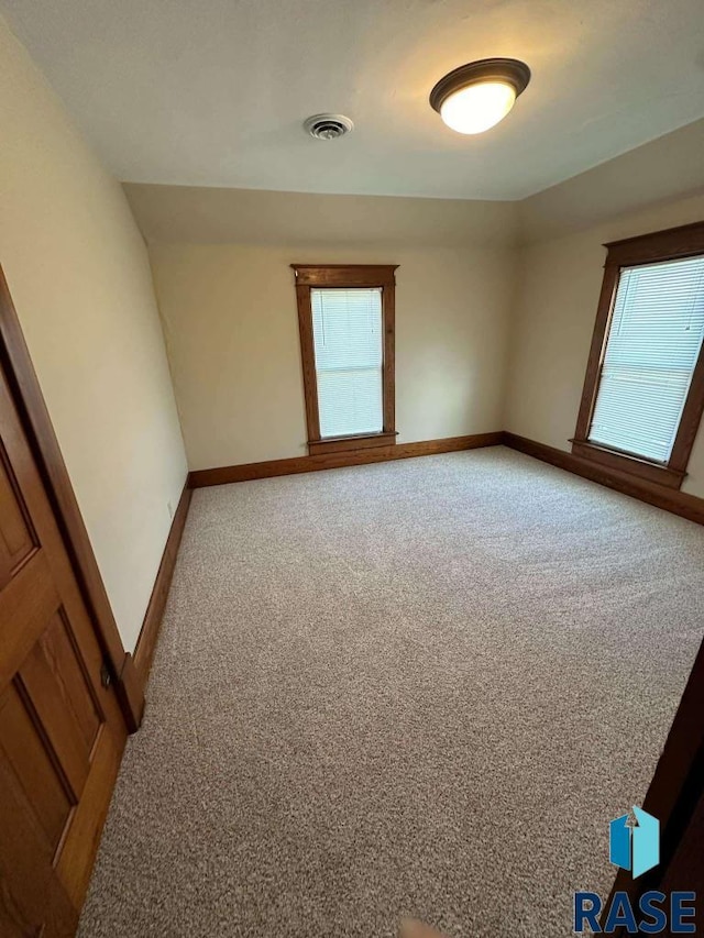 spare room with carpet and plenty of natural light