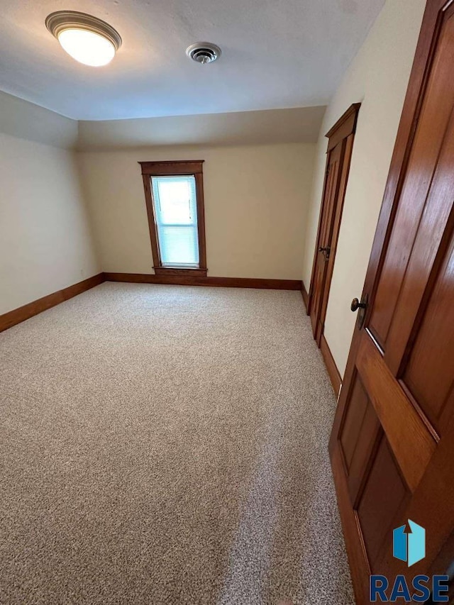 empty room with light colored carpet