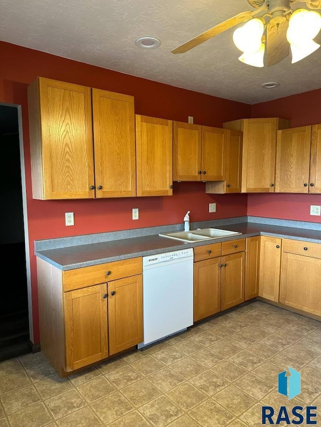 kitchen with ceiling fan, dishwasher, sink, and a textured ceiling