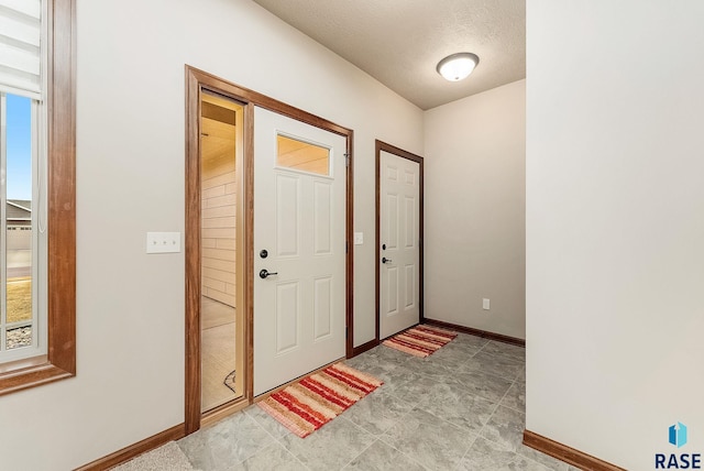 entryway with a textured ceiling