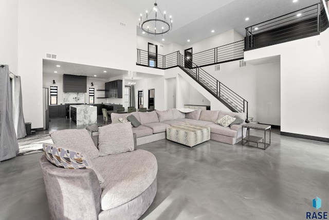 living room with an inviting chandelier and a high ceiling