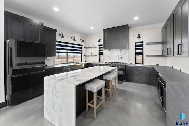 kitchen featuring a breakfast bar, backsplash, a center island, light stone countertops, and black appliances