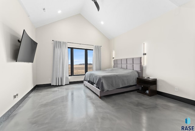 bedroom with concrete flooring and high vaulted ceiling