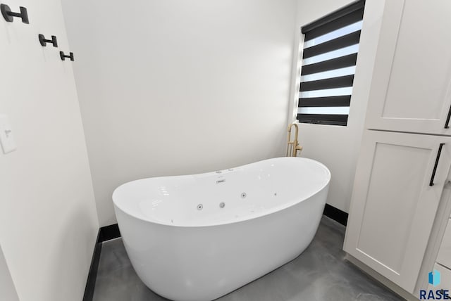 bathroom featuring concrete flooring and a bathtub