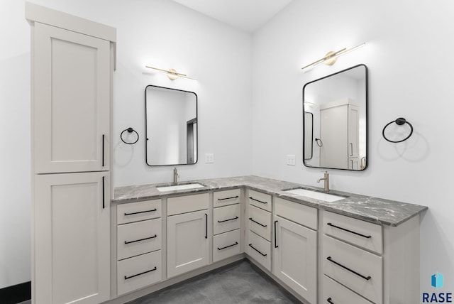 bathroom with vanity and concrete flooring