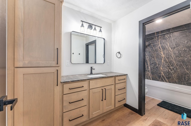 full bathroom with vanity, hardwood / wood-style floors, shower / tub combo with curtain, and toilet