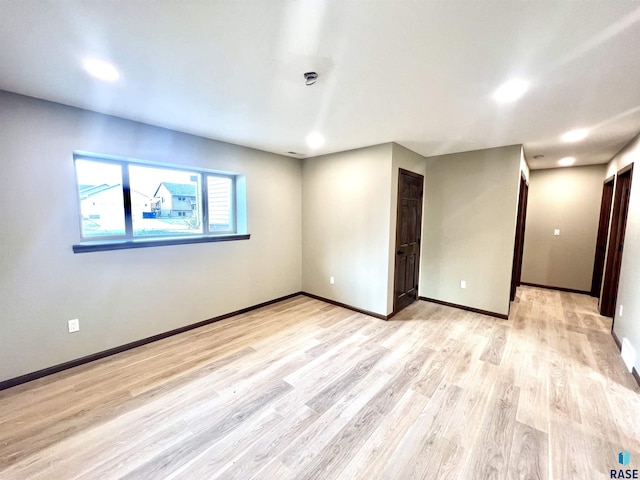 empty room with light hardwood / wood-style flooring