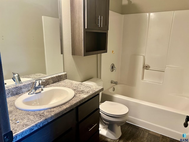 full bathroom featuring hardwood / wood-style flooring, vanity, toilet, and shower / washtub combination