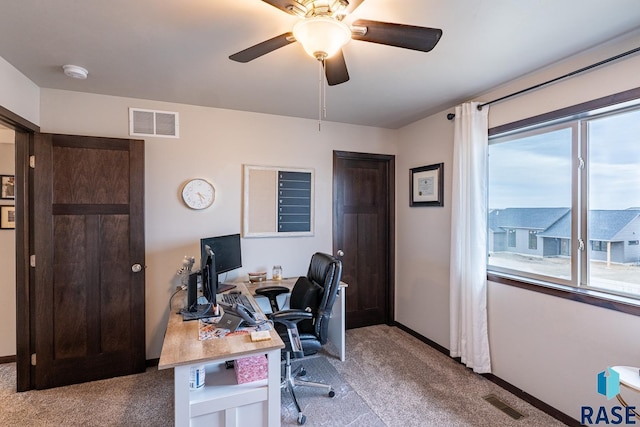 office area featuring light carpet and ceiling fan