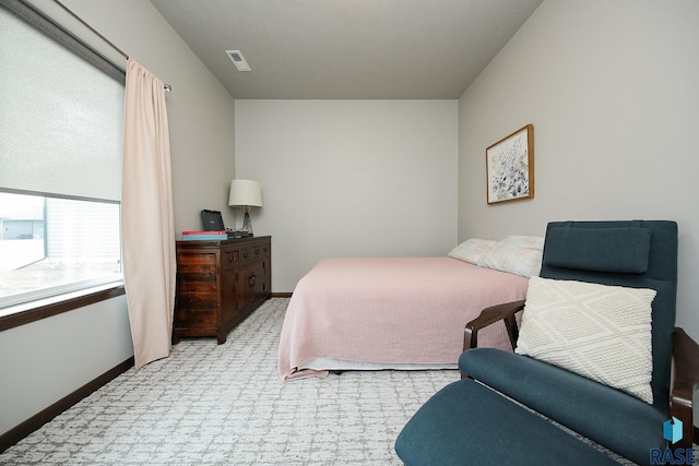 bedroom featuring light carpet