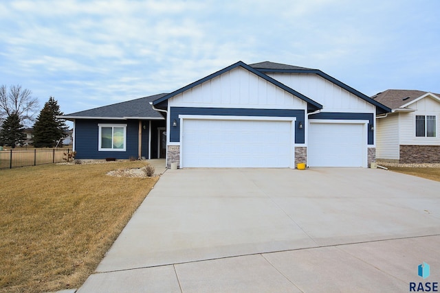 view of front of house featuring a garage and a front lawn