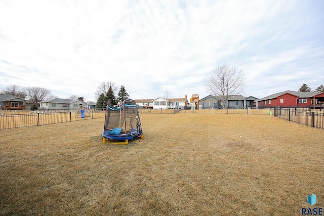 view of yard with a playground and a trampoline