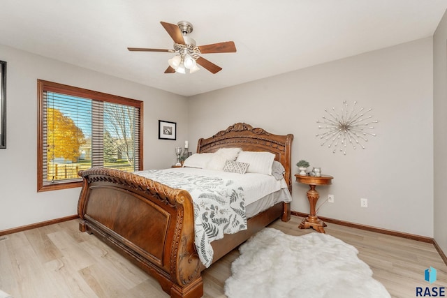 bedroom with ceiling fan and light hardwood / wood-style flooring